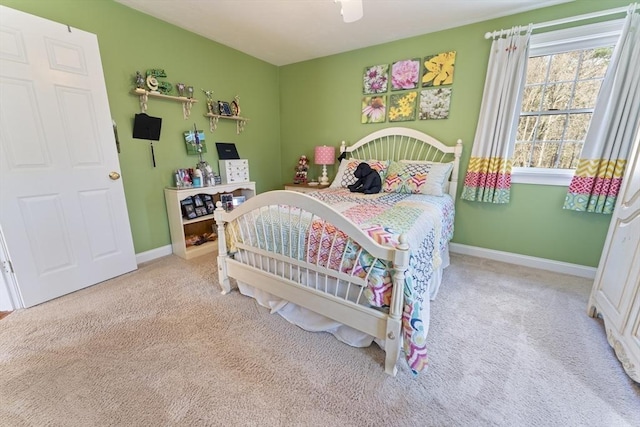 carpeted bedroom with ceiling fan and baseboards