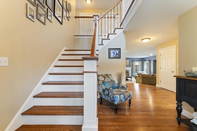 stairs featuring wood finished floors