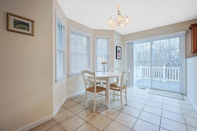 dining room with light tile patterned floors, visible vents, an inviting chandelier, and baseboards