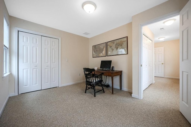 carpeted office space with baseboards