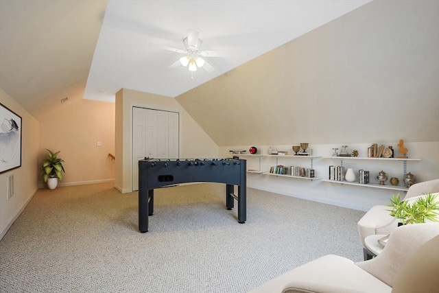 recreation room featuring baseboards, lofted ceiling, carpet, and ceiling fan