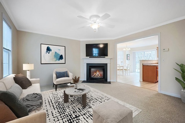 living room with ornamental molding, baseboards, and light carpet