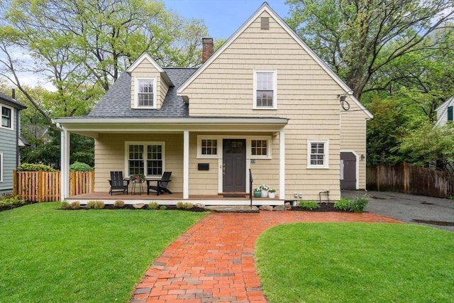 view of front of home featuring covered porch, a chimney, and roof with shingles