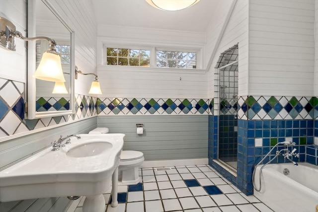 bathroom with a bath, toilet, a sink, tile patterned floors, and a shower stall