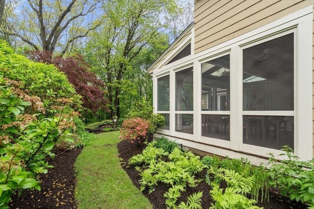 view of side of property featuring a sunroom