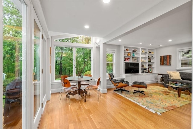 sunroom / solarium featuring wood finished floors, recessed lighting, and baseboards