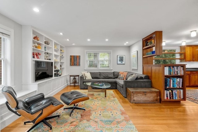 living room with light wood-style floors and recessed lighting