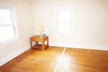 unfurnished room with wood-type flooring