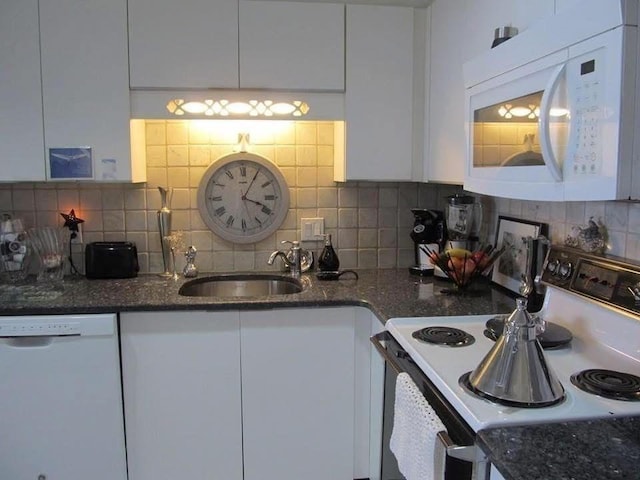 kitchen with decorative backsplash, sink, white cabinets, and white appliances