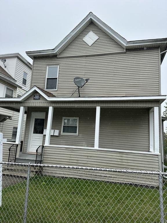 view of front of property with a fenced front yard, a porch, and a front yard