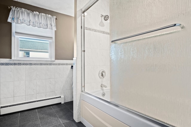 bathroom featuring tile patterned floors, bath / shower combo with glass door, tile walls, and a baseboard heating unit