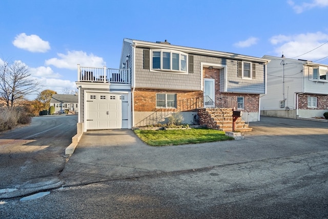 raised ranch with a balcony and a garage