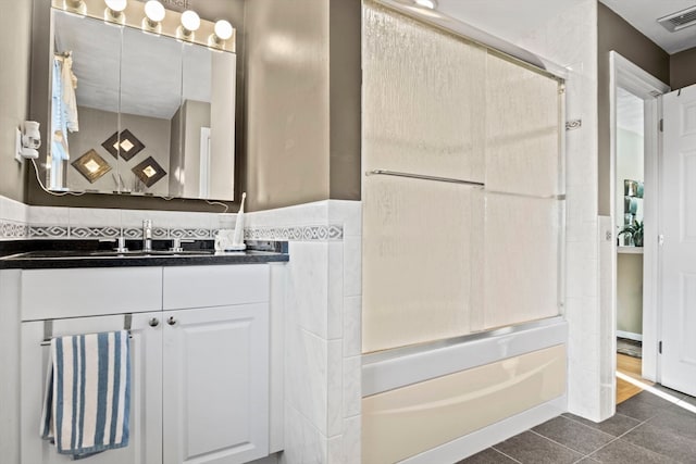 bathroom featuring bathing tub / shower combination, tile patterned flooring, and vanity