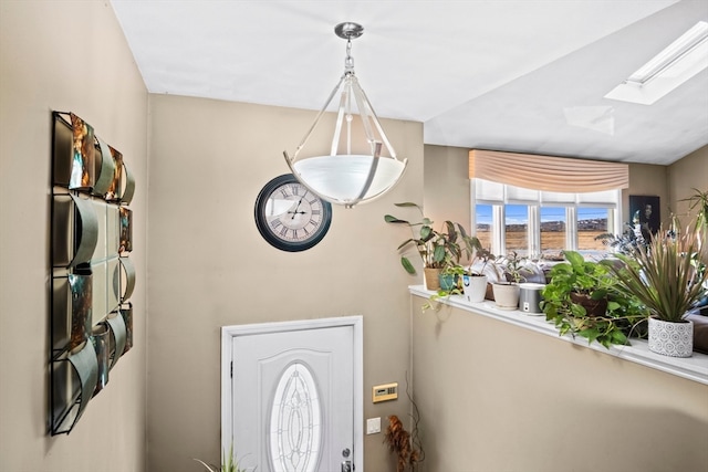 entrance foyer featuring a skylight