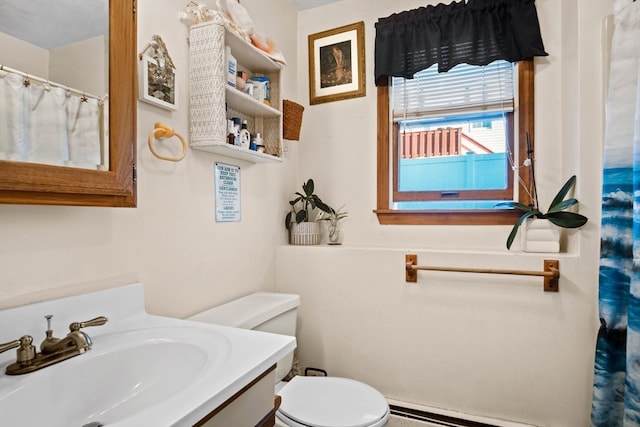 bathroom featuring vanity, toilet, and a baseboard heating unit