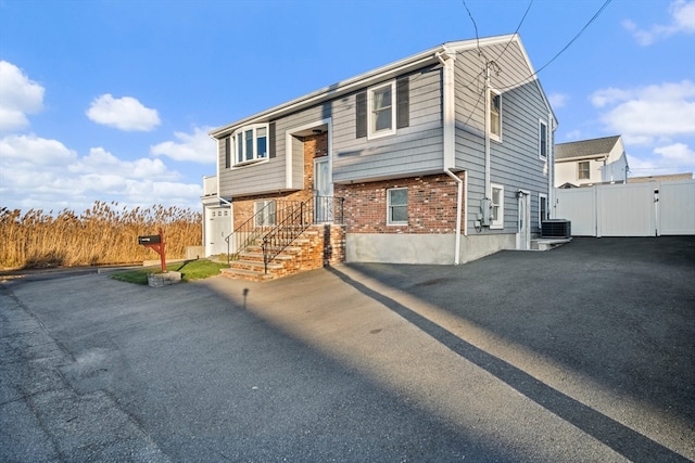 bi-level home featuring central AC unit