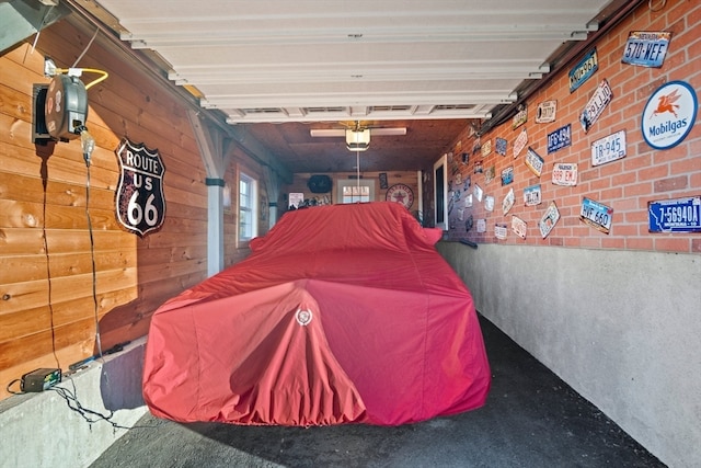 garage with wooden walls and a garage door opener