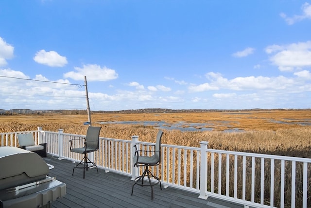 wooden terrace featuring a rural view