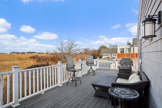 wooden deck with a grill