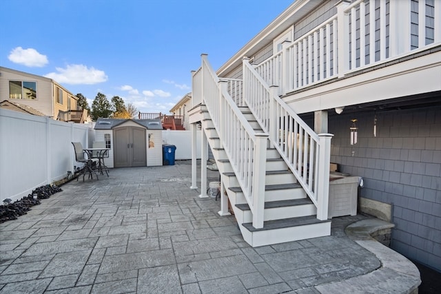 view of patio with a storage shed