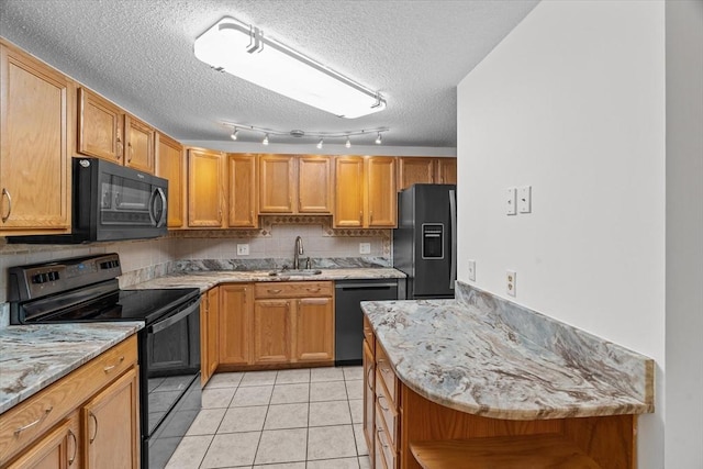 kitchen featuring light tile patterned flooring, sink, backsplash, black appliances, and a textured ceiling