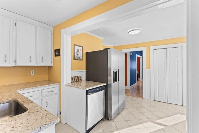 kitchen with white cabinetry, light tile patterned floors, and stainless steel appliances