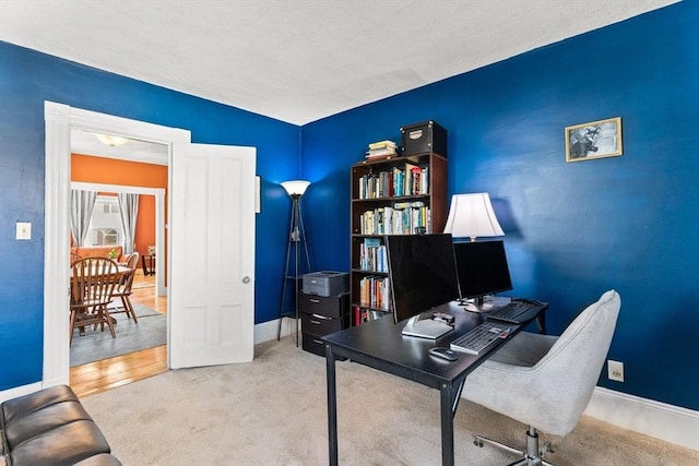 home office with baseboards and carpet