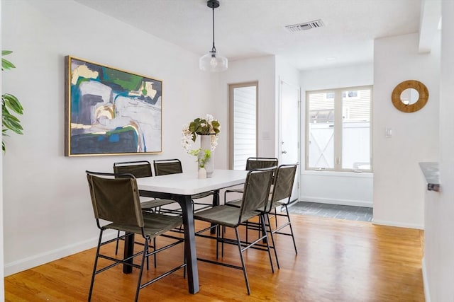 dining room featuring wood finished floors and baseboards