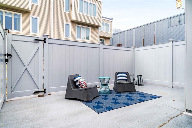 view of patio featuring a fenced backyard and a gate