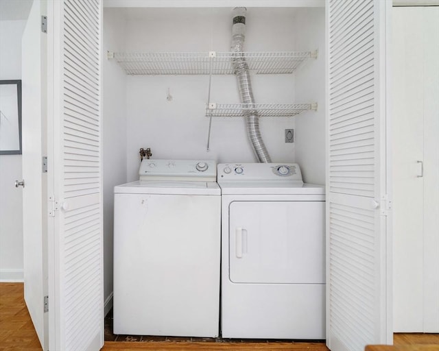washroom with washing machine and clothes dryer