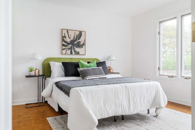 bedroom featuring multiple windows and baseboards