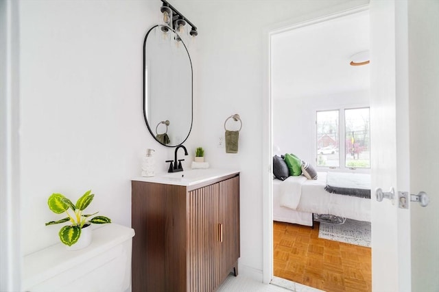 ensuite bathroom featuring toilet and vanity