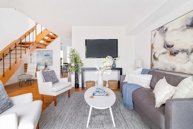 living room featuring stairs and wood finished floors