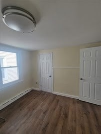 empty room with dark hardwood / wood-style flooring