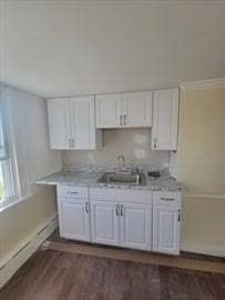 kitchen featuring a sink, white cabinets, and light countertops