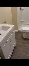 bathroom with toilet, a shower stall, and vanity