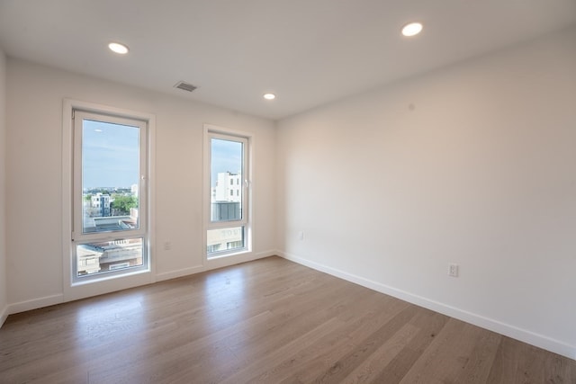 unfurnished room with light hardwood / wood-style floors