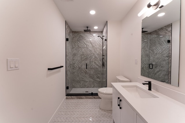 bathroom with tile patterned floors, a shower with shower door, vanity, and toilet