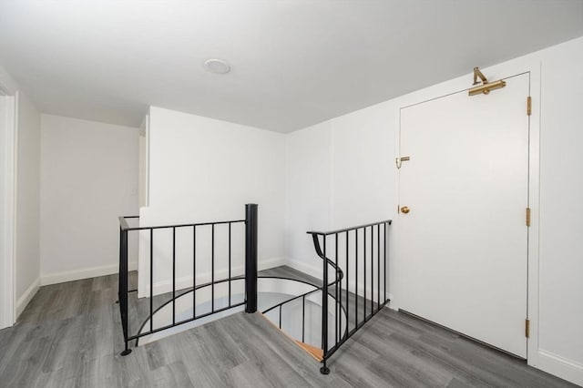 stairs featuring hardwood / wood-style flooring