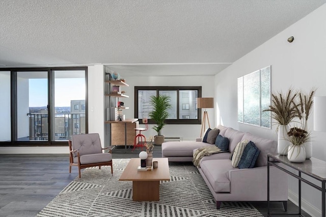 living room featuring hardwood / wood-style flooring, floor to ceiling windows, a textured ceiling, and baseboard heating