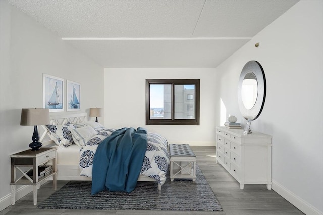 bedroom featuring hardwood / wood-style floors and a textured ceiling