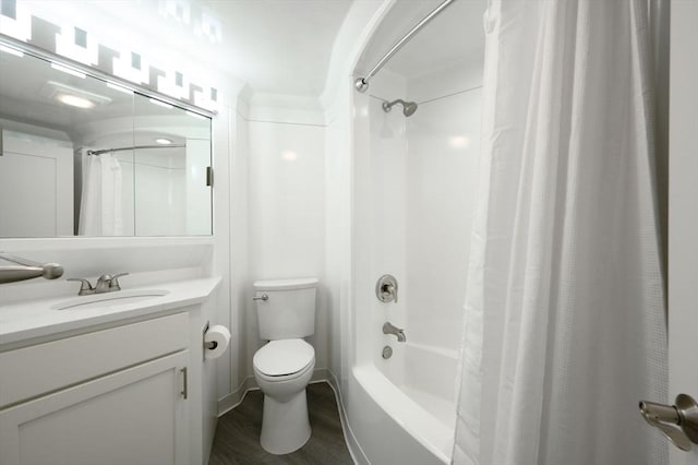 full bathroom with hardwood / wood-style flooring, vanity, shower / tub combo with curtain, and toilet