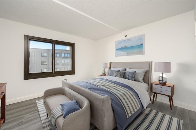 bedroom with dark hardwood / wood-style flooring