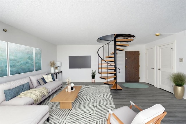 living room featuring dark hardwood / wood-style flooring and a textured ceiling