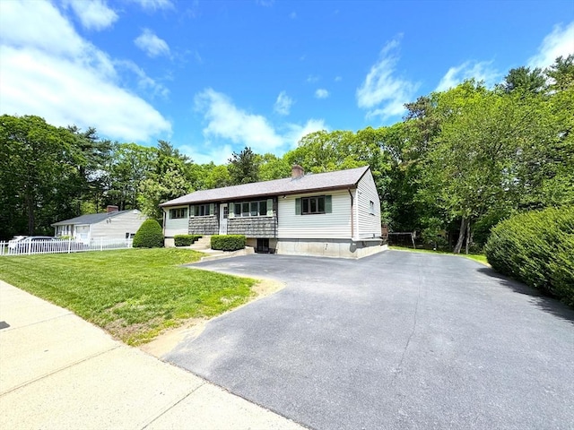 6 Oak St, Foxboro, MA 02035 - view of front of home with asphalt driveway, view of scattered trees, and a chimney