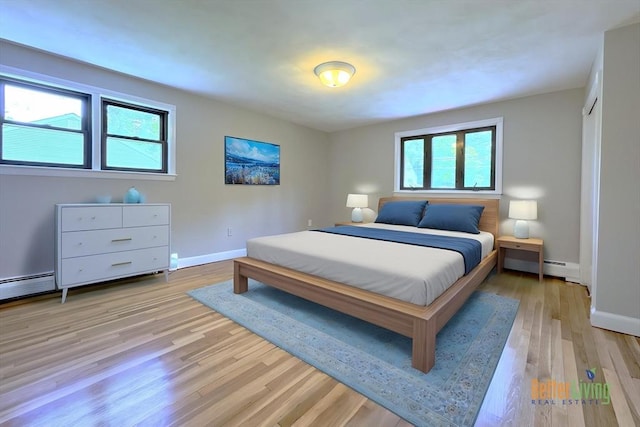 6 Oak St, Foxboro, MA 02035 - bedroom with baseboards, a baseboard radiator, and light wood-style floors
