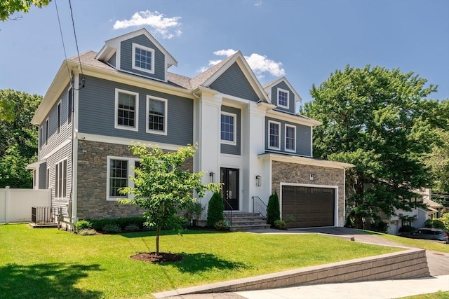 view of front facade with a garage and a front lawn