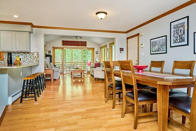 dining room featuring crown molding, light wood-style floors, recessed lighting, vaulted ceiling, and a baseboard heating unit