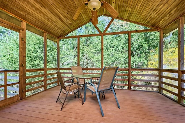 sunroom / solarium with a wooden deck, outdoor dining space, ceiling fan, and lofted ceiling