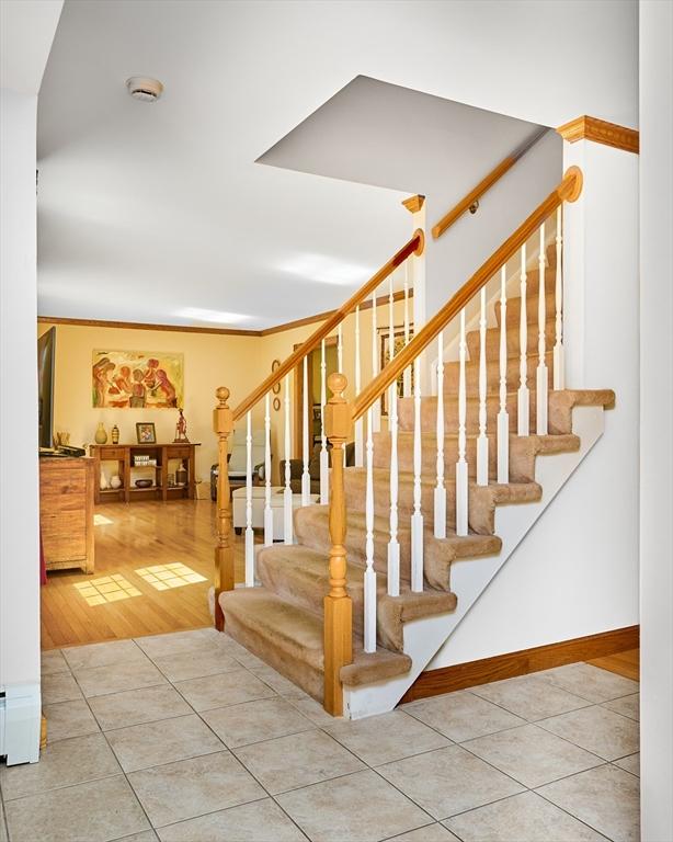staircase with tile patterned floors and baseboards